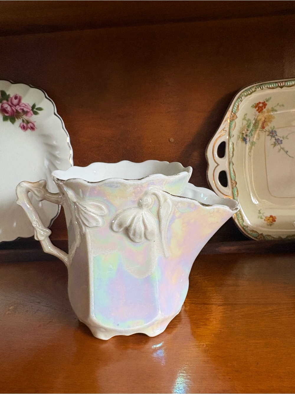 Iridescent White Porcelain Pitcher with Floral Relief